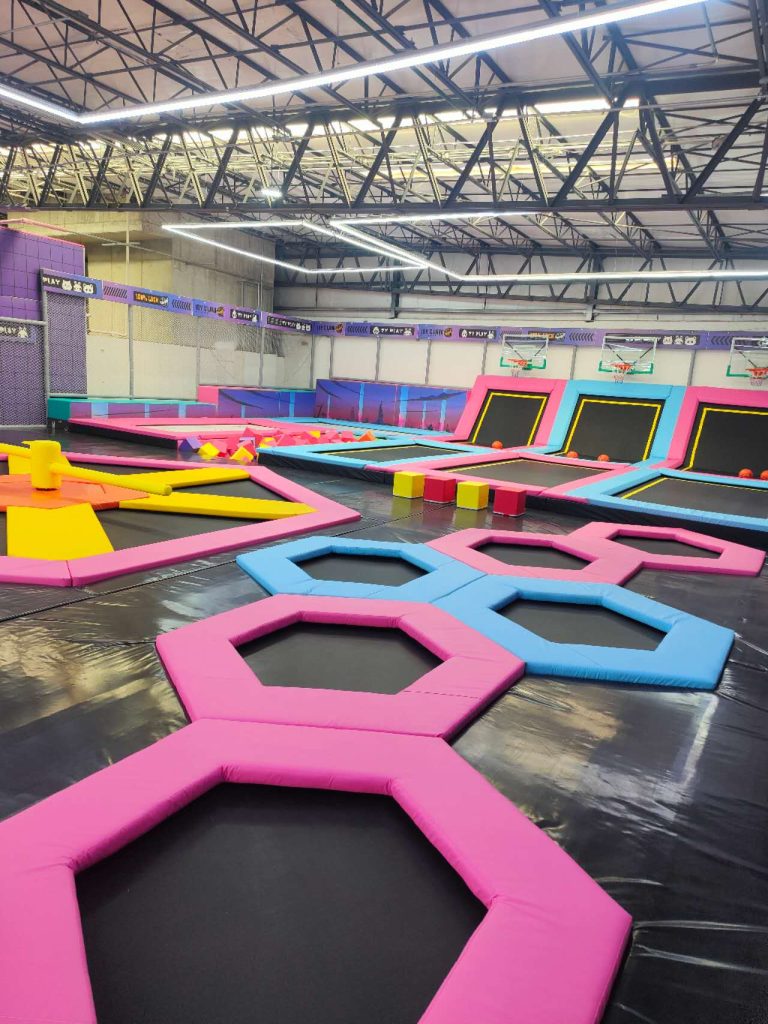 Pink and blue hexagonal trampoline activity zone