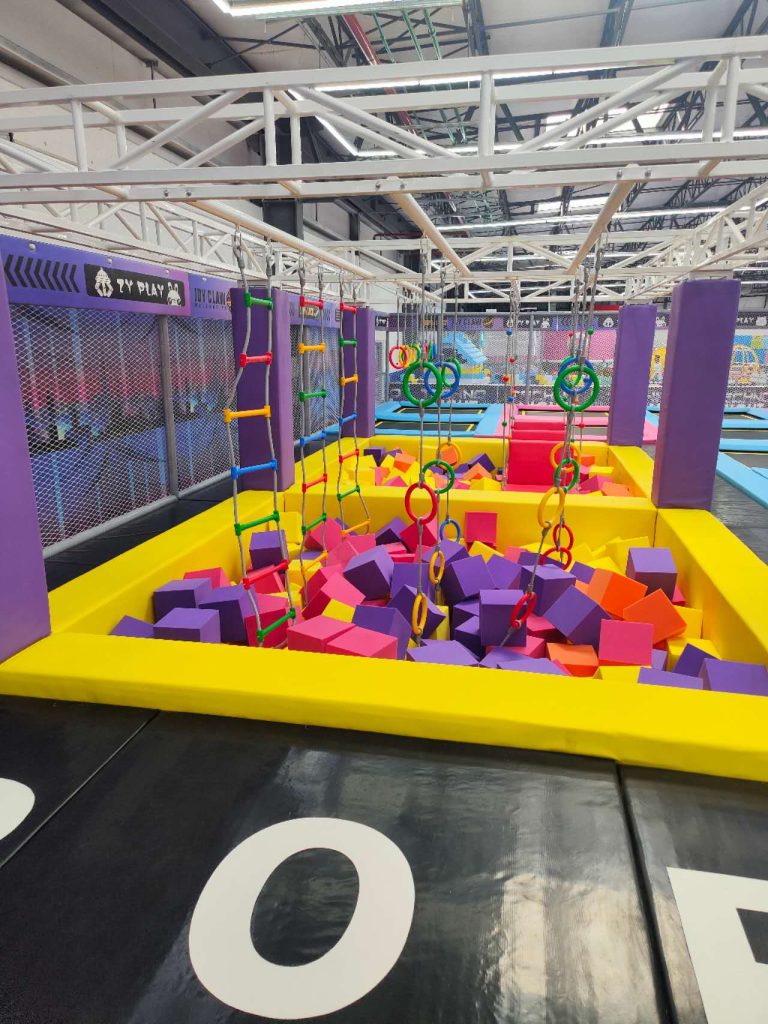 Bright foam pit with hanging obstacles