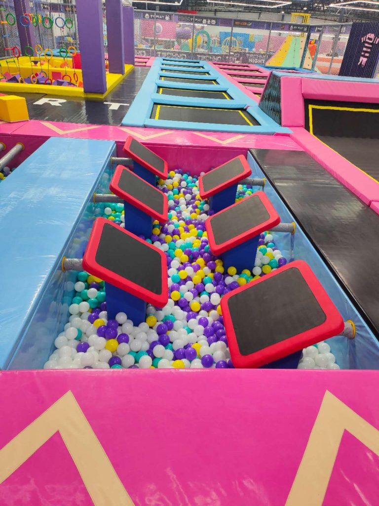 Stepping challenge above a colorful ball pool