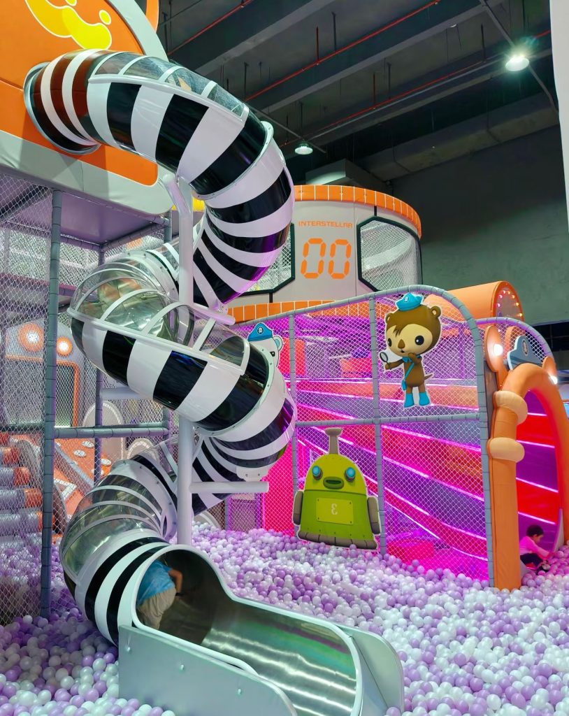 Black and white tube slides in a family play zone